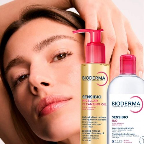 Image of model with radiant skin beside a bottle of Sensibio H2O Micellar Water and Sensibio Micellar Cleansing Oil